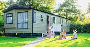 family playing outside a static caravan