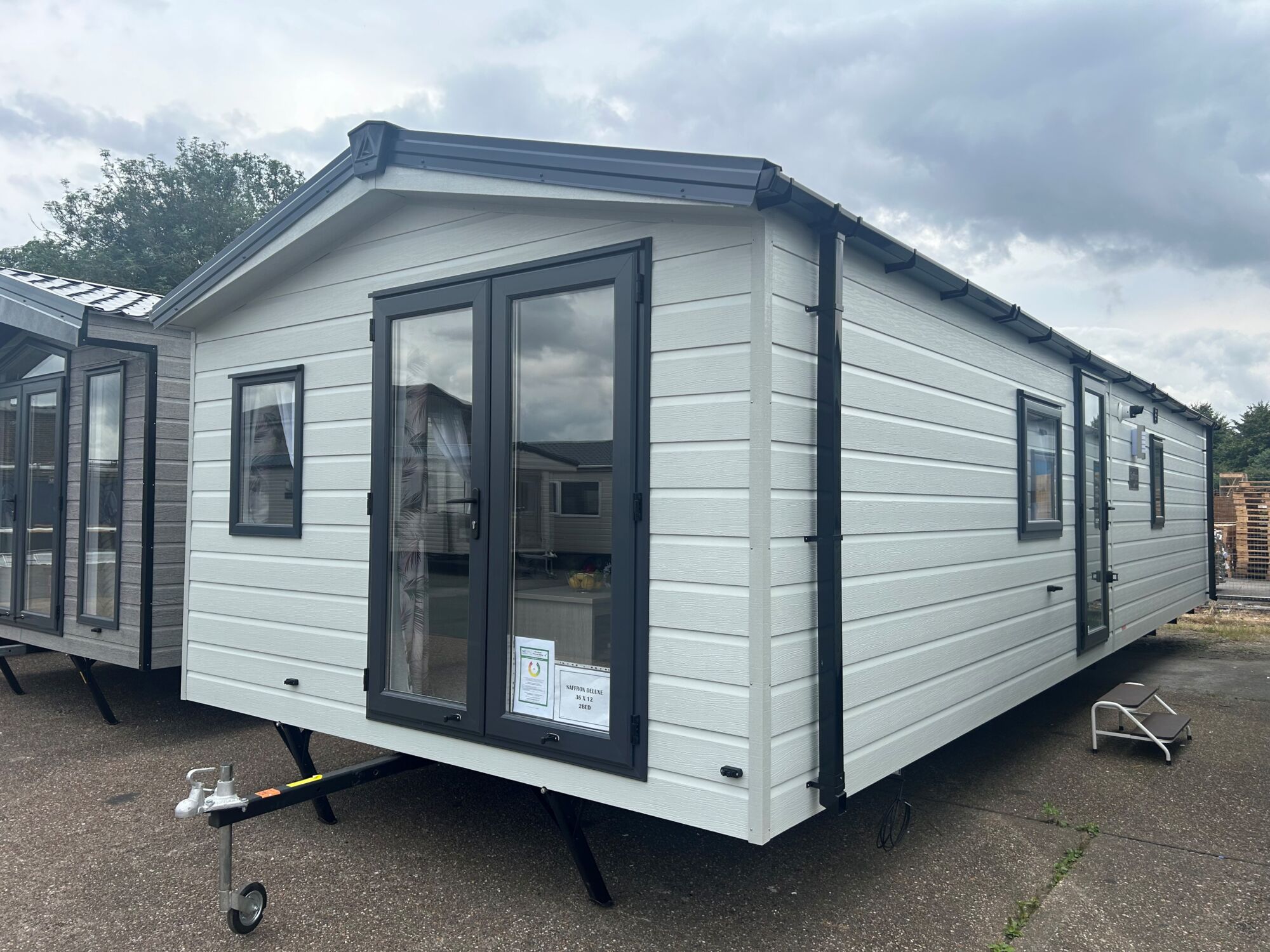 New Delta Saffron Deluxe Static Caravan exterior with french doors